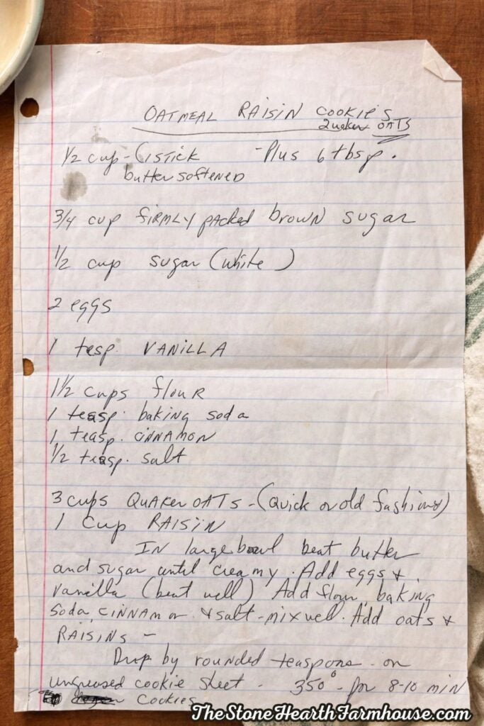 Handwritten oatmeal raisin cookie recipe on lined paper with ingredient measurements and baking instructions