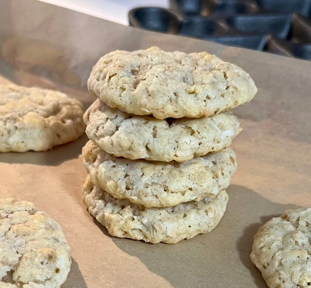 Stack of homemade ranger cookies with oats and coconut on parchment paper