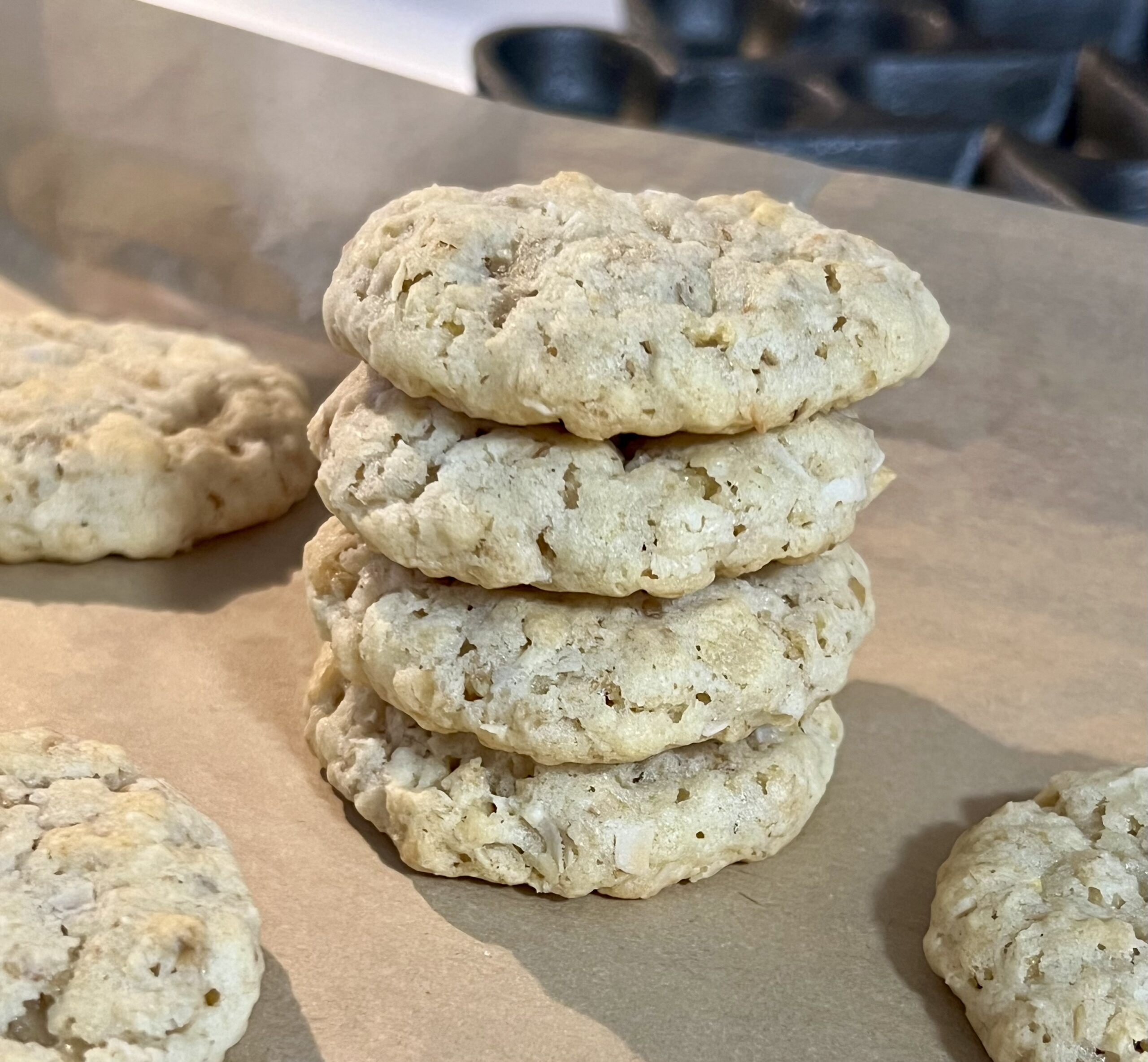 Stack of homemade ranger cookies with oats and coconut on parchment paper