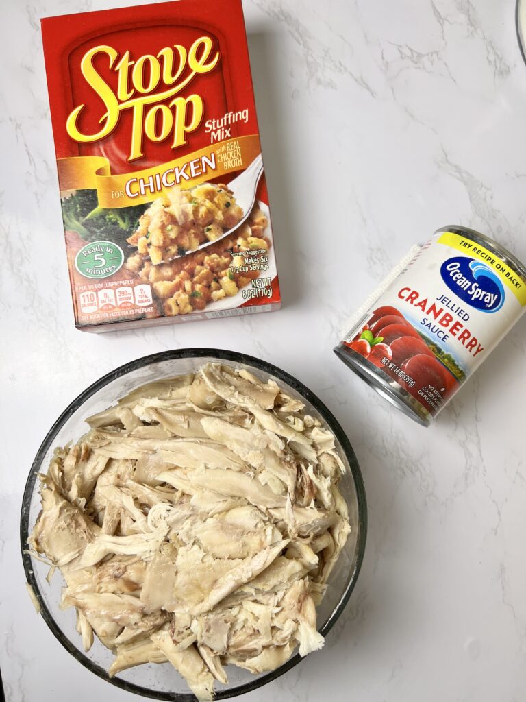 Ingredients for thanksgiving lasagna with leftovers including shredded turkey, stuffing mix, and cranberry sauce