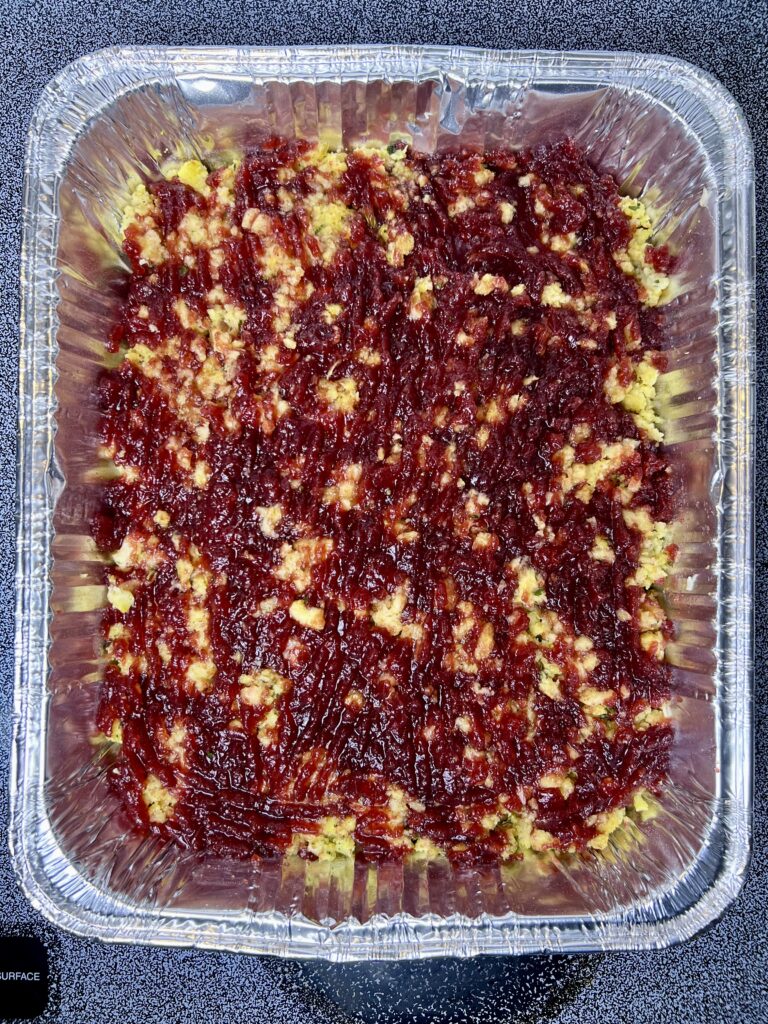 Cranberry sauce layer in a thanksgiving casserole with leftovers, adding sweet contrast to turkey and stuffing