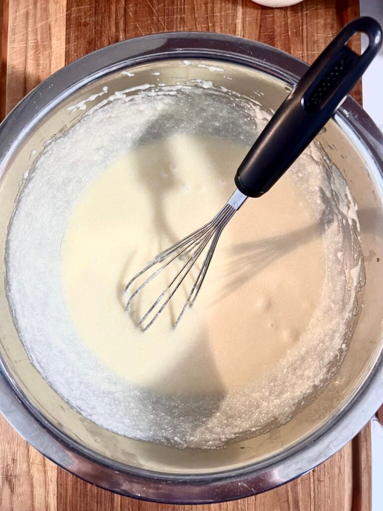 Wet ingredients being mixed for ricotta cookies in a bowl. 