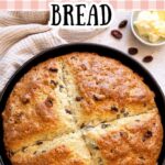 Pinterest graphic featuring a golden round loaf of sourdough Irish soda bread with raisins and text reading “Sourdough Irish Soda Bread.”