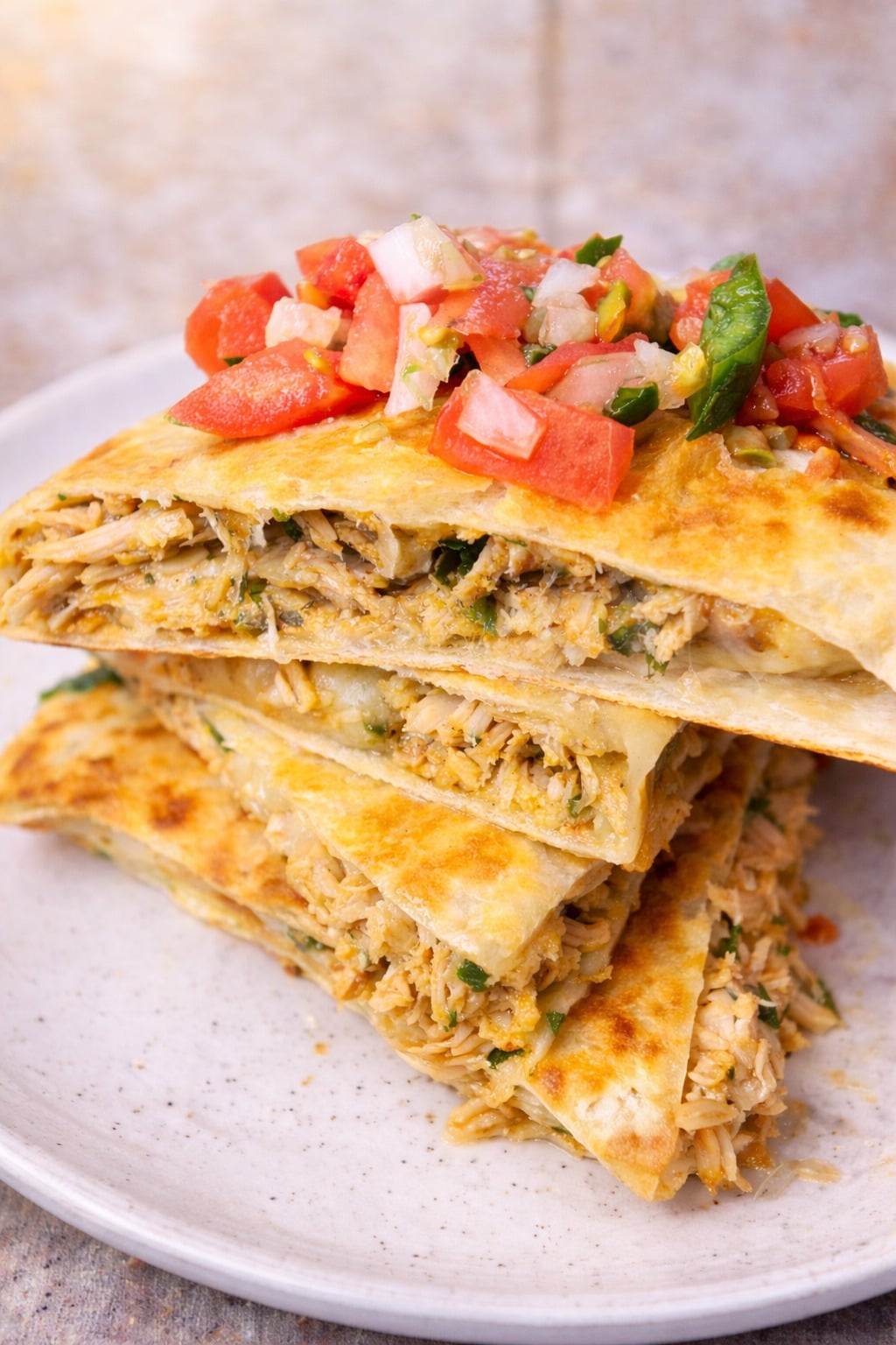 Easy authentic Mexican chicken quesadilla recipe with stacked cheesy chicken quesadillas, juicy shredded chicken filling, melty cheese, and fresh pico de gallo topping