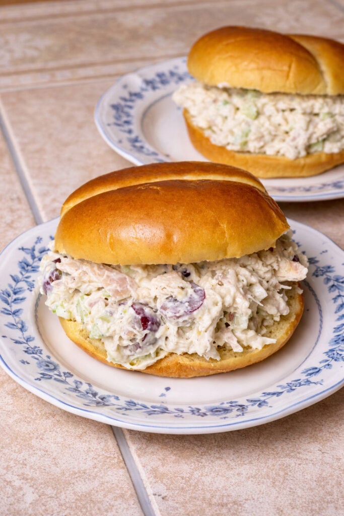 Best chicken salad recipe for a crowd served as sandwiches on soft buns with creamy chicken salad filling