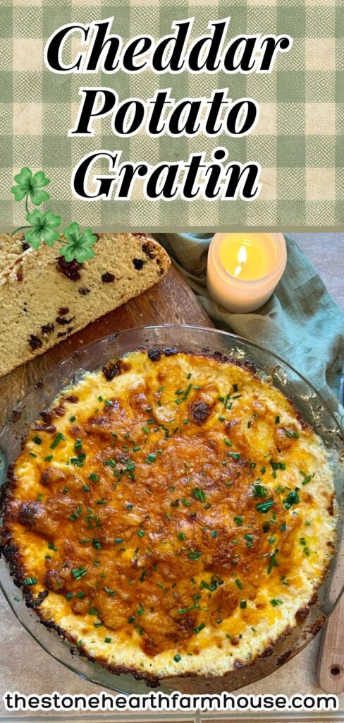Cheddar potato gratin baked in a glass dish with golden brown cheesy top and fresh chives, creamy Yukon gold potato gratin served as an easy holiday side dish.