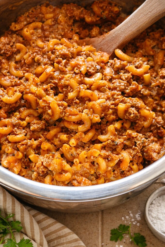 Close-up of american chop suey recipe beef with tender macaroni, seasoned ground beef, and thick tomato sauce, classic comfort food meal