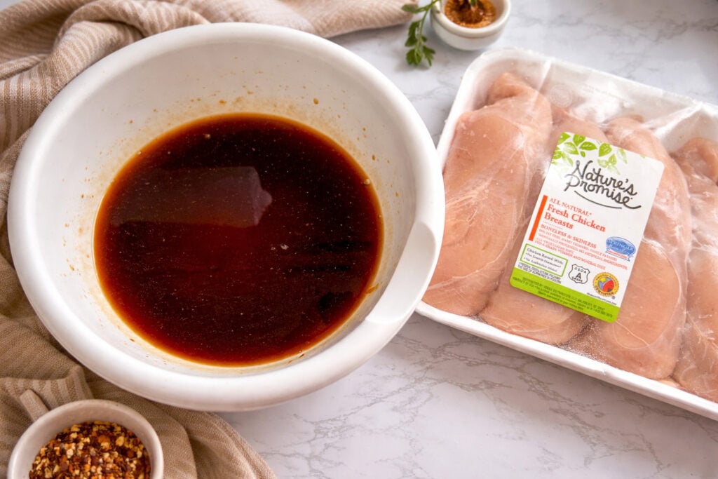 Huli Huli chicken marinade in bowl with raw chicken breasts ready for easy Instant Pot recipe