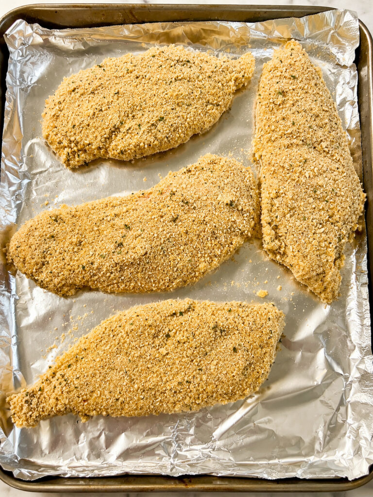 applebees lemon chicken recipe with crispy hand-breaded chicken breasts prepared on a baking sheet before cooking