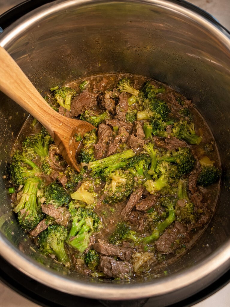 Instant Pot beef and broccoli fully cooked in savory sauce with tender beef strips and broccoli florets.