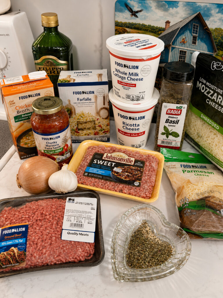 Ingredients for instant pot lasagna casserole including ground beef, Italian sausage, ricotta cheese, mozzarella, pasta sauce, and farfalle pasta on a kitchen counter