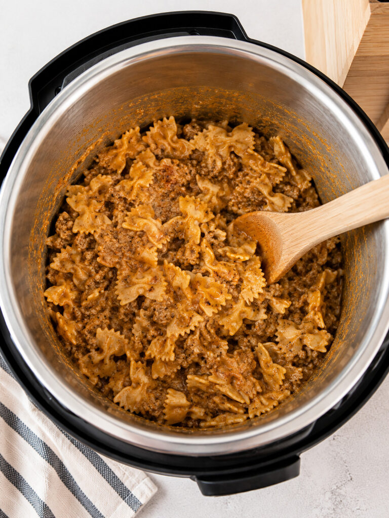 Creamy cheesy pasta and meat mixture inside an Instant Pot after cooking