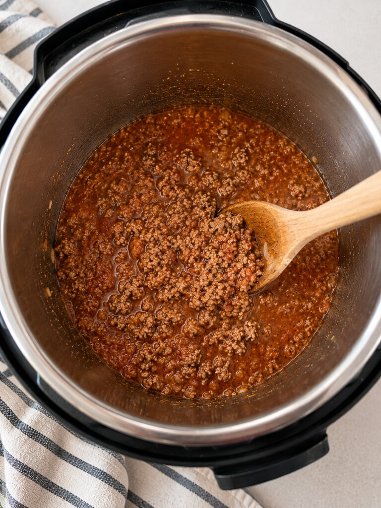 Meat sauce simmering in the Instant Pot with ground beef and marinara sauce