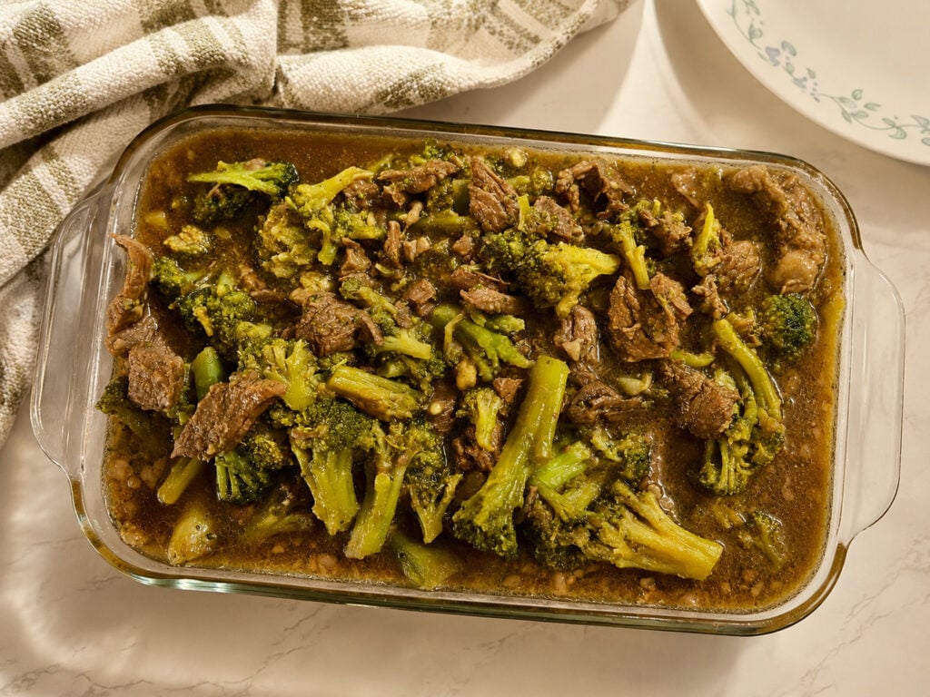 Keto beef and broccoli Instant Pot recipe in a glass casserole dish with tender beef, broccoli, and rich low carb sauce.