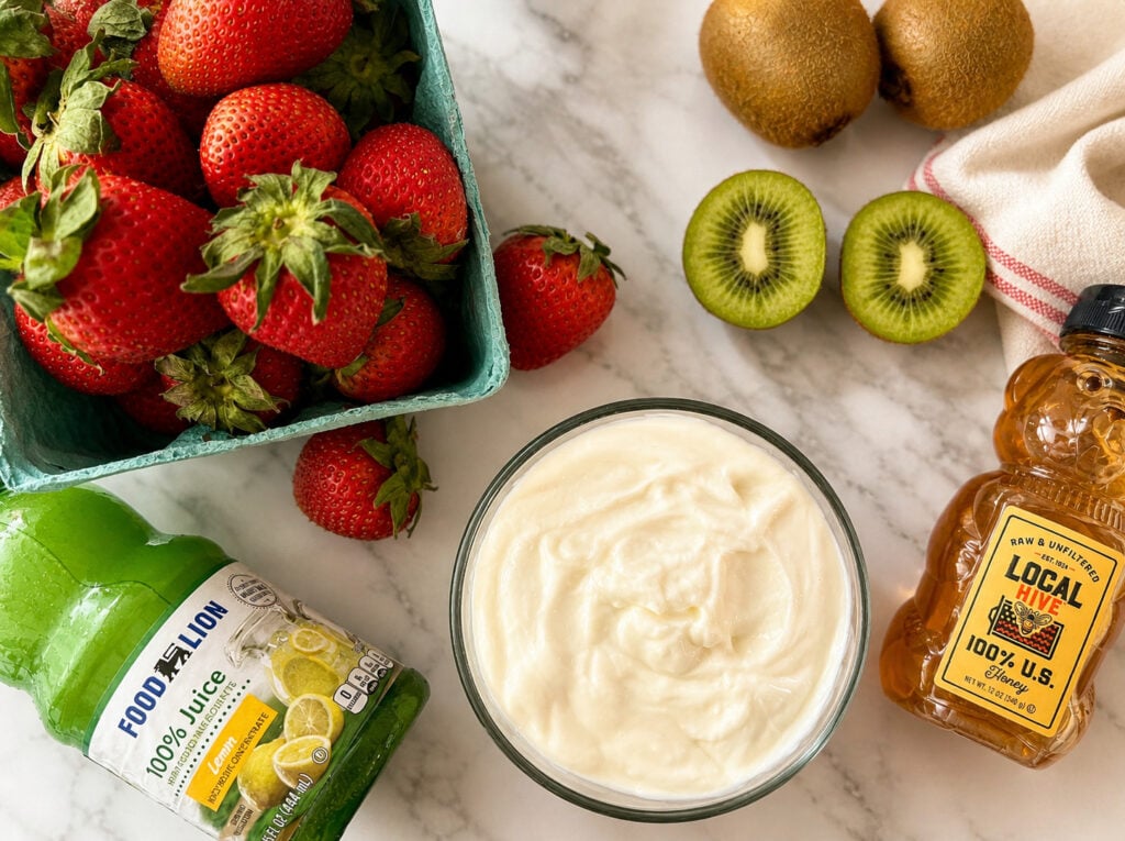 Strawberries, kiwi, yogurt, honey, and lemon juice ingredients for strawberry kiwi popsicles