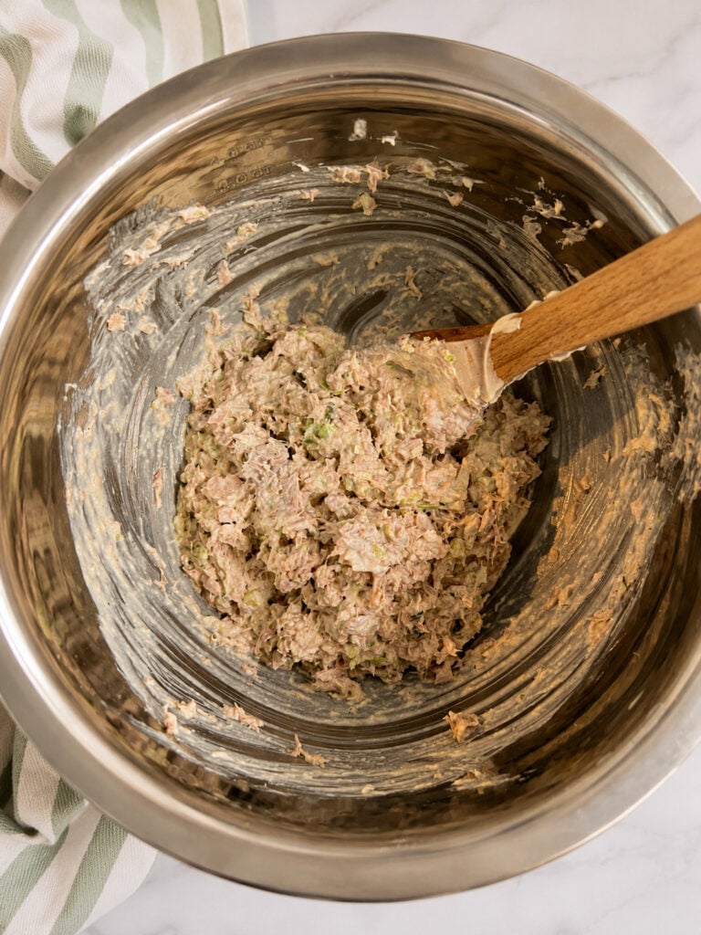 Creamy homemade Subway tuna salad mixture in a stainless steel bowl with a wooden spatula for an easy copycat sandwich recipe.