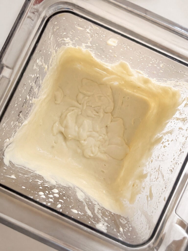 Smooth banana ice cream mixture blended until creamy inside a blender jar. This easy 3 ingredient banana ice cream recipe uses ripe bananas, heavy cream, and brown sugar.