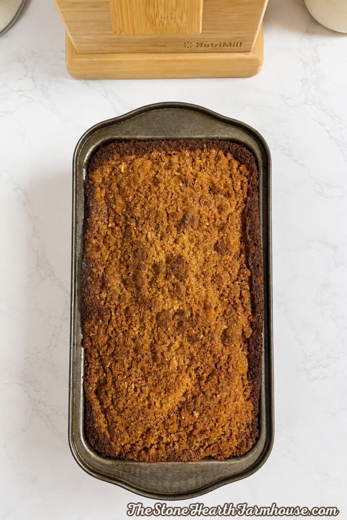 Golden brown fresh milled pumpkin bread with a cinnamon streusel topping after baking