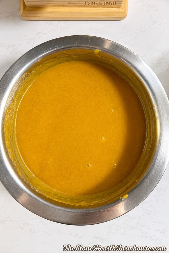 Pumpkin bread wet ingredients whisked together in a stainless steel mixing bowl
