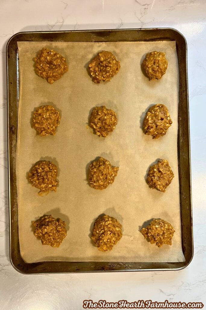 12 cookies on a parchment lined baking sheet, ready to go into the oven. 