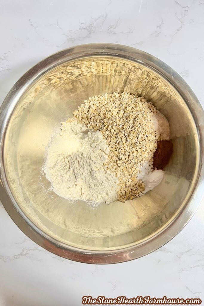 a stainless steel bowl with dry ingredients in it, unmixed. 