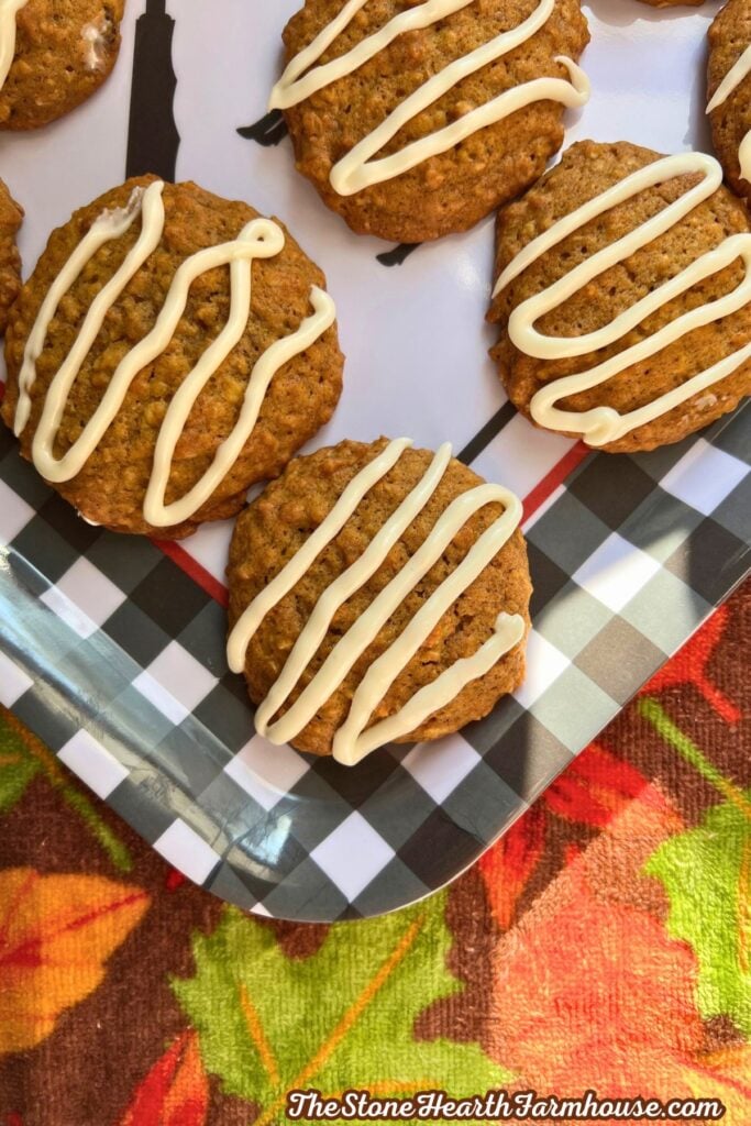 a close up of the cookies on a tray with a fall background with icing on top.