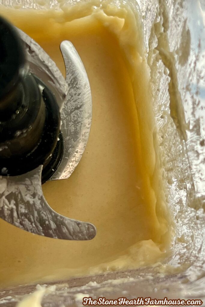 Smooth pumpkin cheesecake filling blended until creamy in a food processor