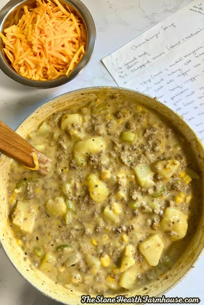 almost done, just added cheddar cheese and milk. soup in a pot